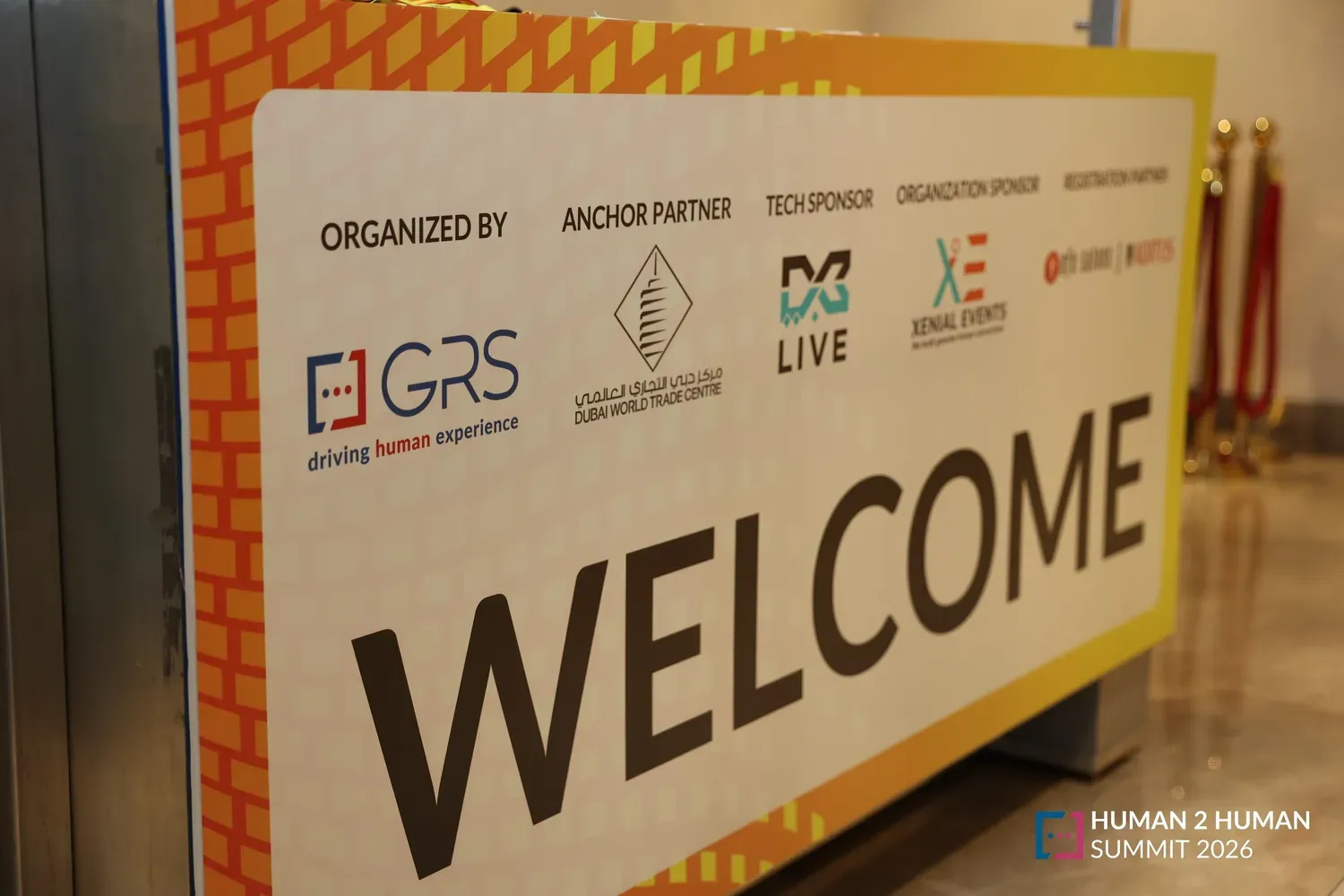 The large welcome wall at the summit, carrying the GRS logo alongside anchor partner and sponsor logos