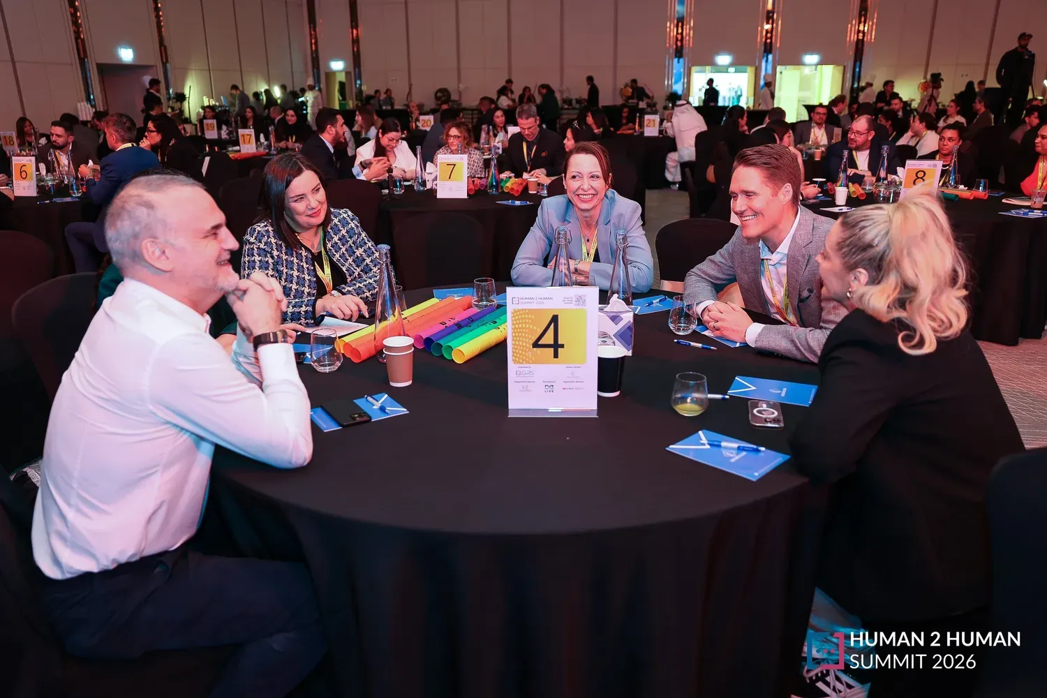 A mixed group of delegates in discussion around round table 4